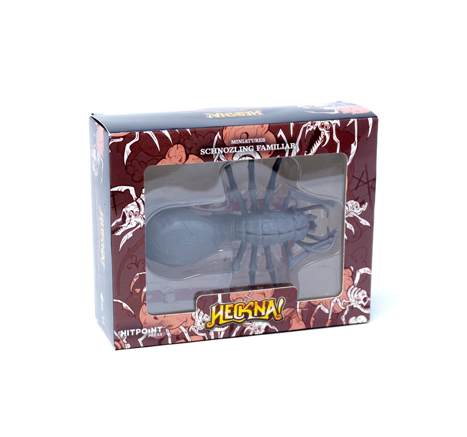 A gray Schnozling Familiar miniature is packaged in a dark red, patterned Heckna! game box with a clear window.