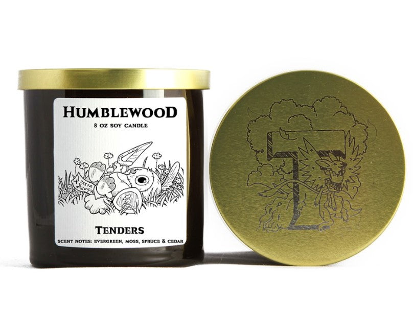 Humblewood Tenders soy candle in a dark jar, with a stitched bunny label and a gold lid featuring an etched dragon "T".