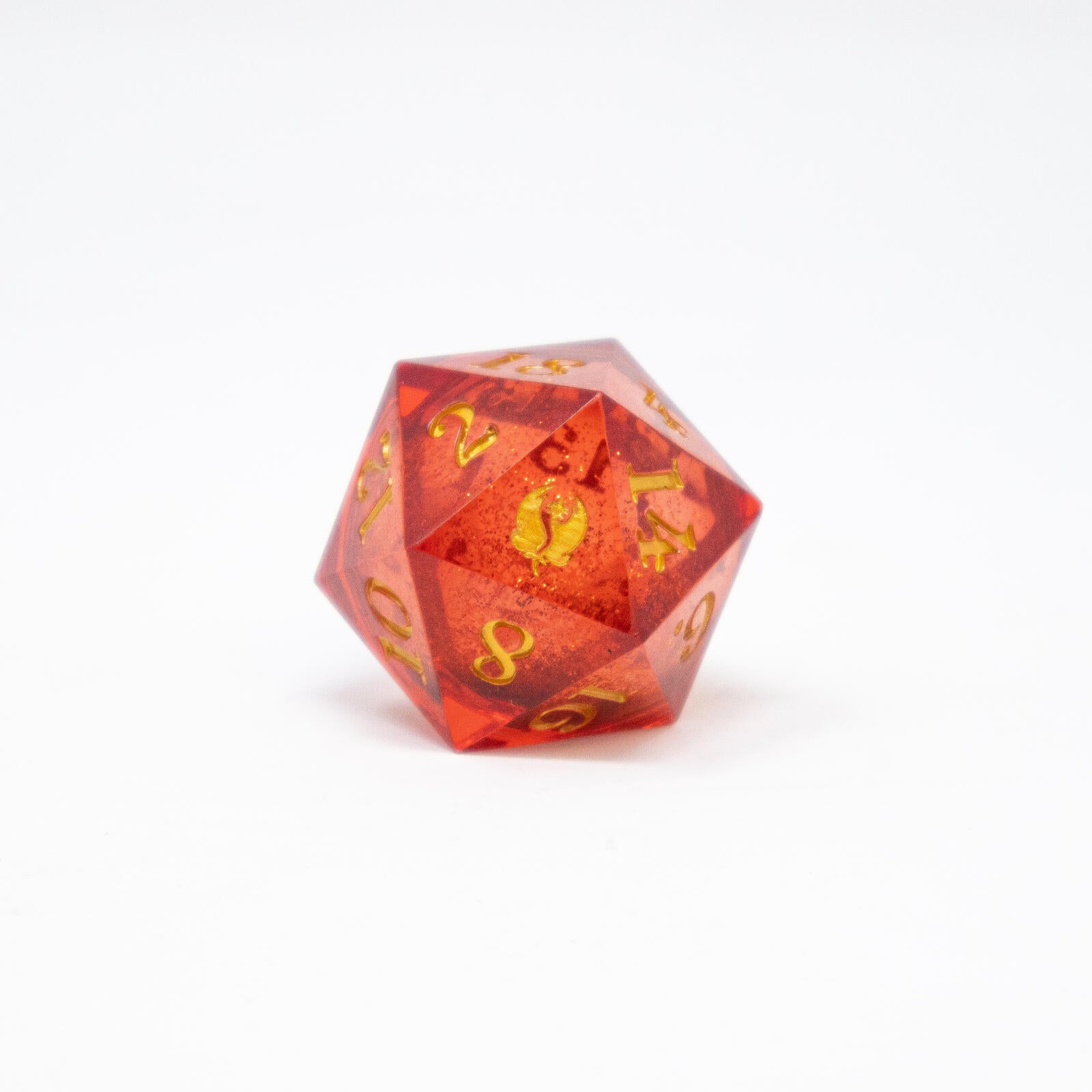 A bloom pink liquid core D20 dice with gold numbers sits on a white background