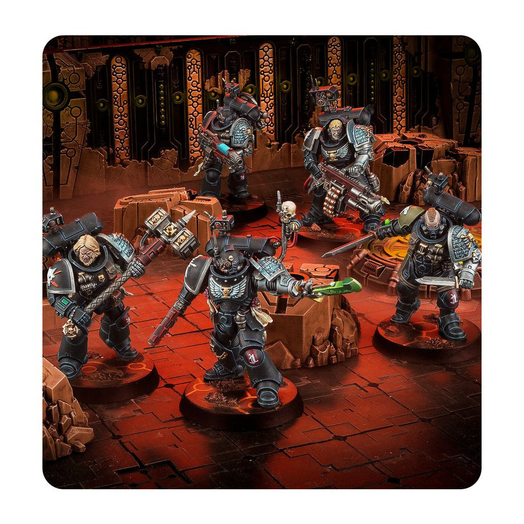 Five black Space Marine miniatures with power armor and weapons (hammer, bolter, sword) on a red sci-fi wargaming table