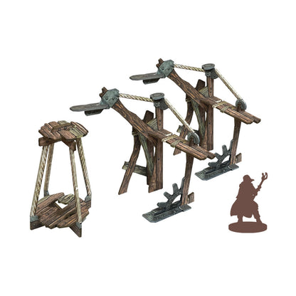 Fantasy tabletop miniatures: Two detailed wooden catapults, a rope basket, and a robed character silhouette
