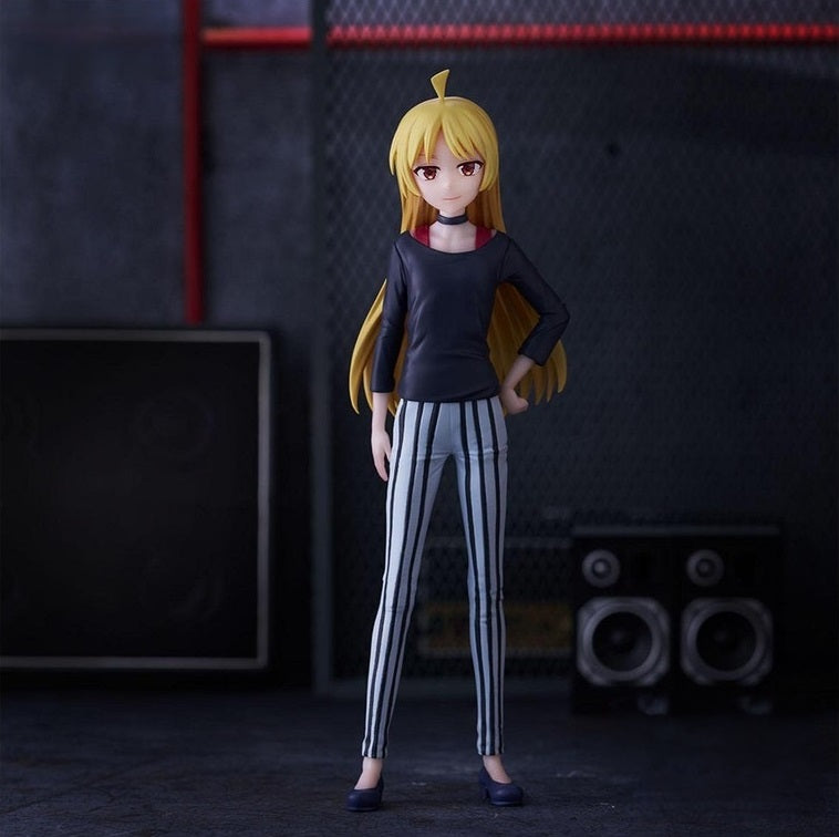 Figure of a female character with long blonde hair wearing a black shirt and black and white striped pants