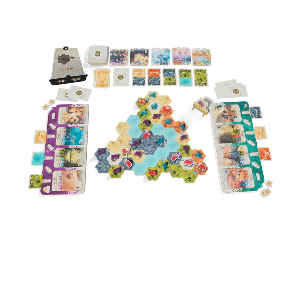 Overhead view of a laid-out board game featuring multicoloured hexagonal map tiles, player mats, and multiple decks of illustrated cards