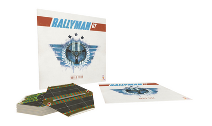 The Rallyman GT board game box stands upright with a flat game component and a stack of race track tiles in front