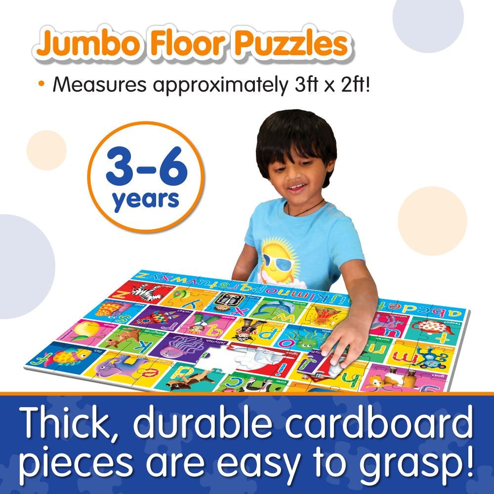 Young child assembling a colourful, jumbo alphabet floor puzzle (ABC)
