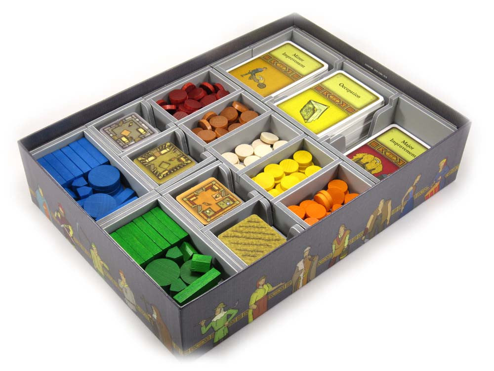 Side view of foam insert being pulled out from Agricola game box