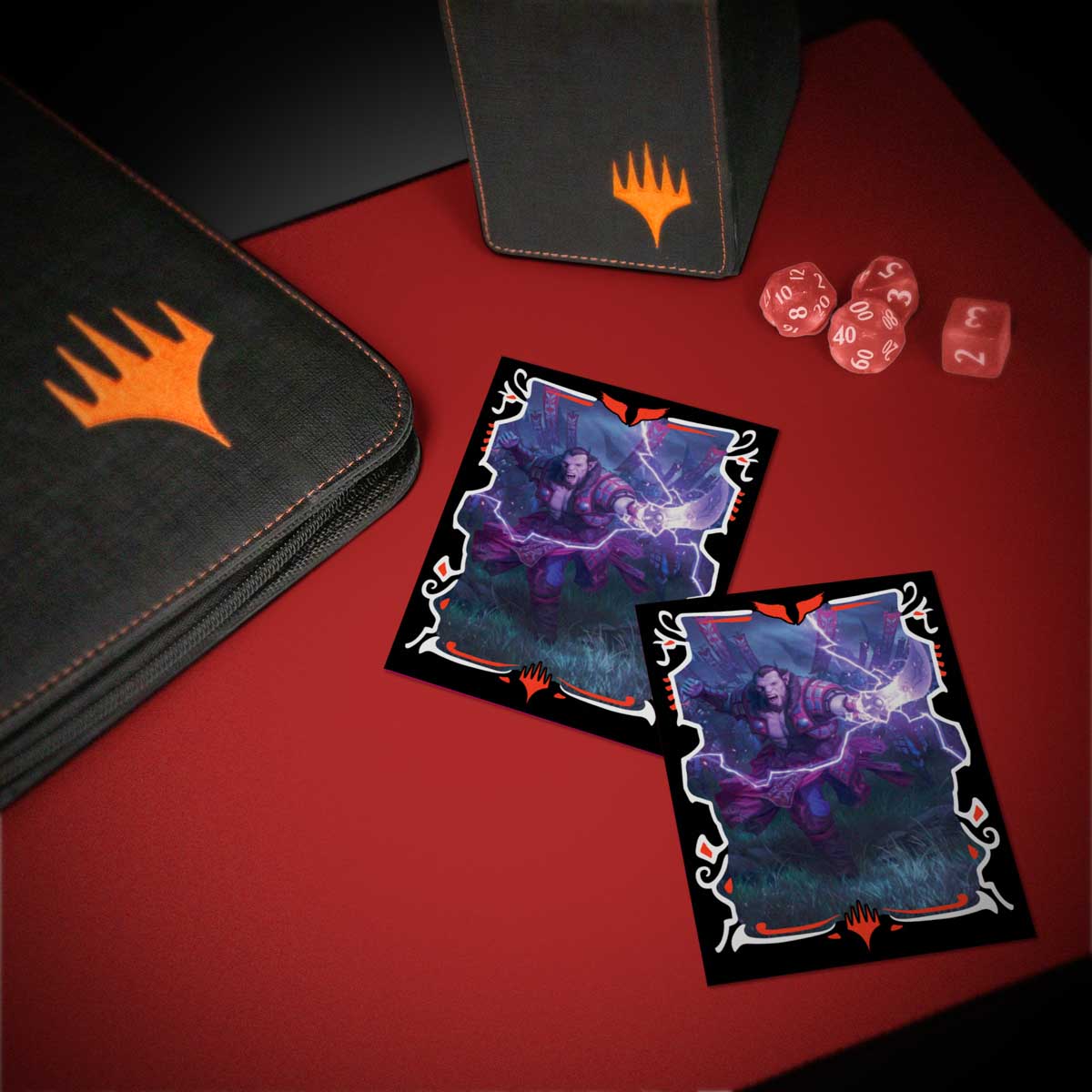 Two MTG cards show a figure casting lightning. An MTG binder, deck box, and dice sit on a red table