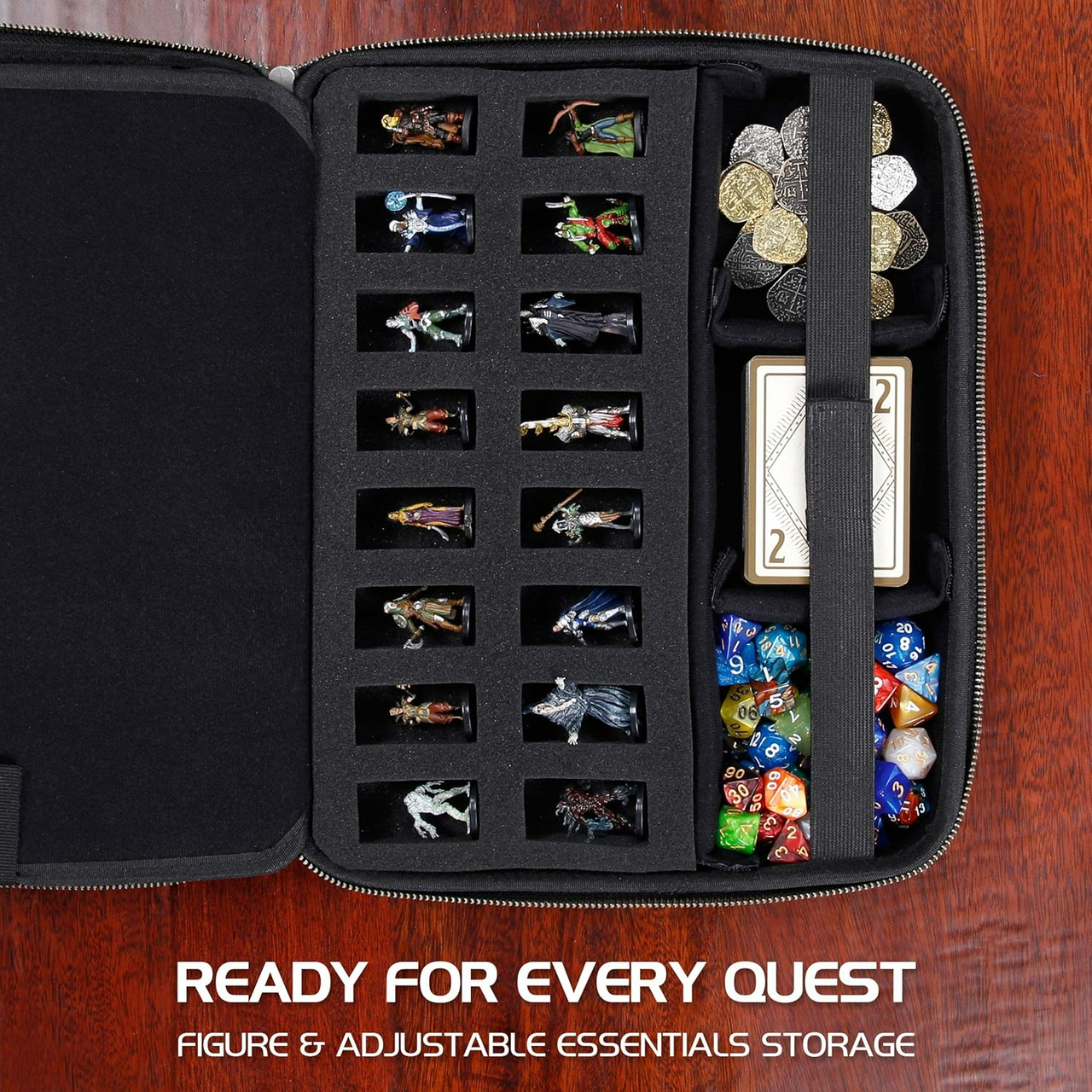 An open black case organized with fantasy miniatures, polyhedral dice, coins, and cards for tabletop RPGs.