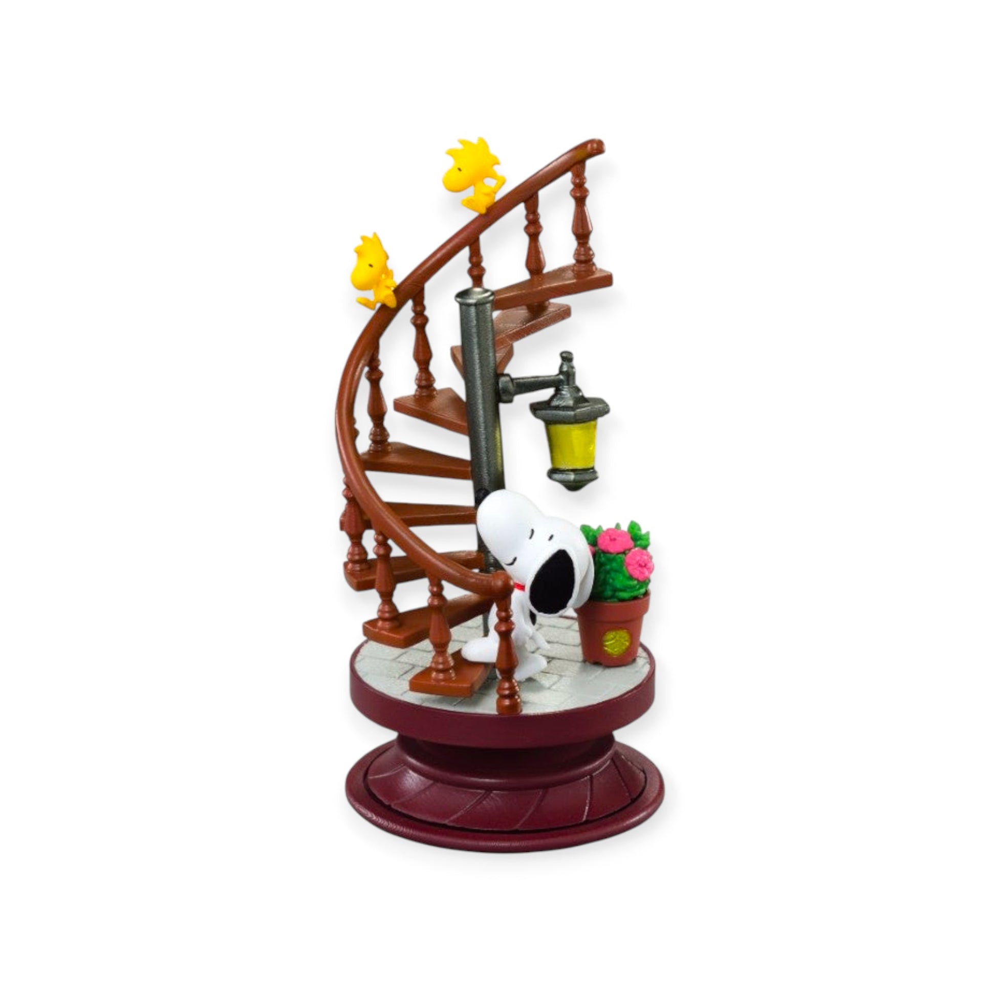 Snoopy and two Woodstocks on a miniature spiral staircase figurine with a street lamp and potted plant