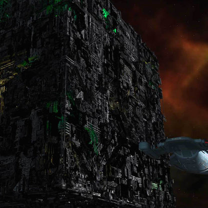 A huge Borg Cube, covered in green lights and mechanical details, looms in space as a Starfleet ship approaches