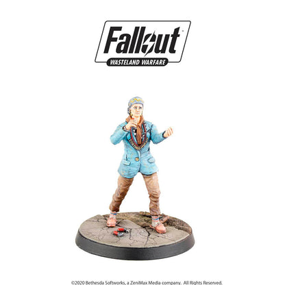 A Fallout Wasteland Warfare miniature: Woman in blue jacket, headscarf, and beaded necklace, gesturing on a cracked base