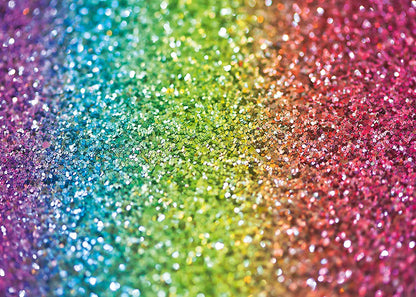 Vibrant rainbow glitter background featuring a spectrum of colors from purple blue green yellow orange to pink with sparkling sequins