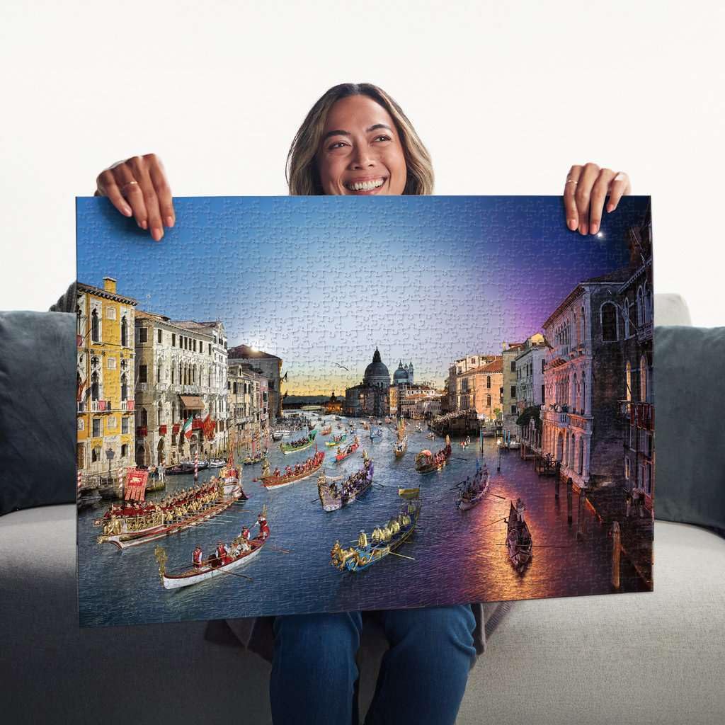 A woman proudly displays the finished 1000-piece Ravensburger Venice by Night jigsaw puzzle showing the Grand Canal filled with historic boats