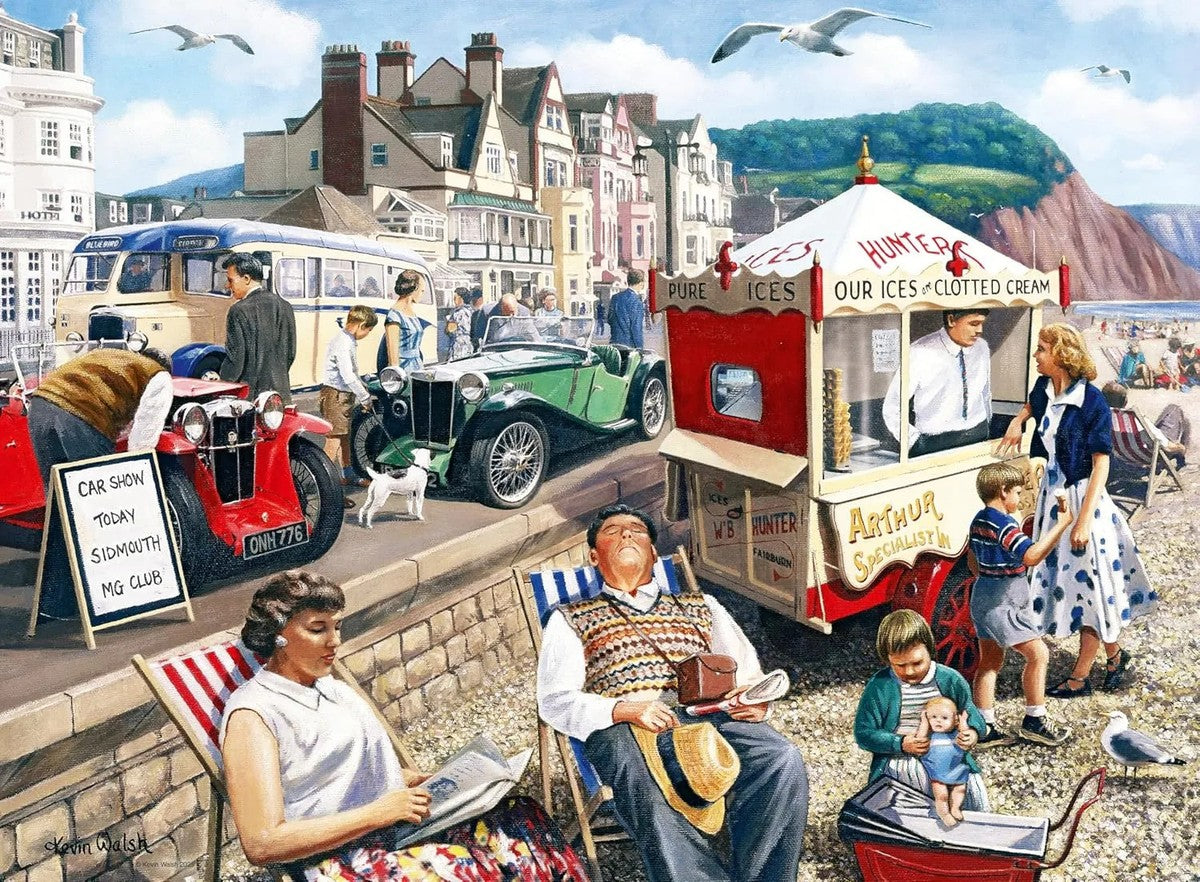 Painting depicting a nostalgic British holiday scene featuring vintage cars on display, sunbathers, and an ice cream stall near the busy seafront