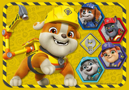 Close-up of Rubble wearing a yellow hard hat and construction gear with four hexagonal framed images of his smiling crew on a caution-striped background