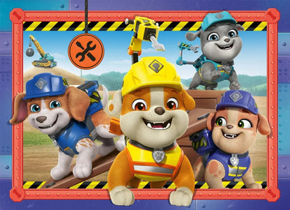 The Rubble and Crew team of four construction pups, all wearing hard hats, smile excitedly within a vibrant orange and blue metal frame