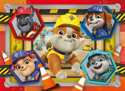 The Rubble & Crew jigsaw box features Rubble the construction bulldog pup smiling in the center, encircled by four joyful pups and a cat in brightly colored hexagonal frames