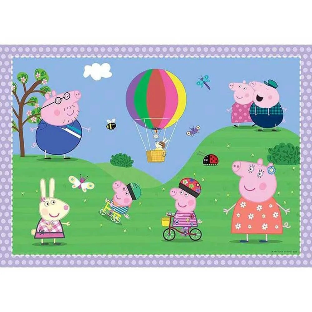 A cheerful Peppa Pig illustration depicting the family and Rebecca Rabbit enjoying a sunny picnic on green hills featuring a large multicolored hot air balloon and butterflies