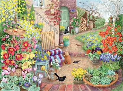 A vibrant Glorious Gardens jigsaw depicting a blooming cottage garden with diverse flowers, birds, a cat, and a hedgehog on a brick patio