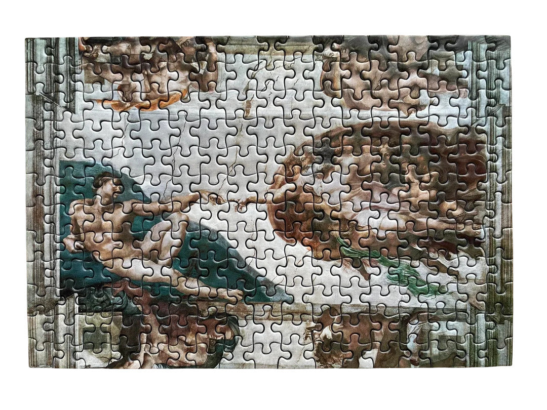 The assembled Ravensburger 5000 piece puzzle depicting Michelangelo’s Creation of Adam fresco on a white background