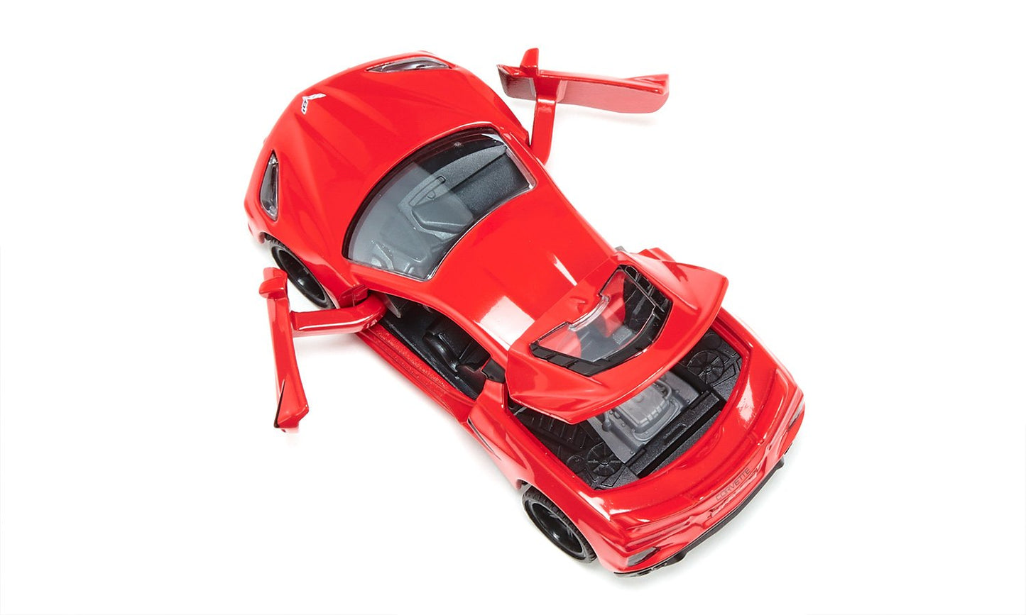A red toy Chevrolet Corvette C8 Stingray model car with both doors and the rear engine cover open, viewed from above on a white background