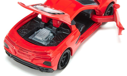 A red toy Chevrolet Corvette C8 Stingray with its rear engine cover open revealing a gray engine and the driver's side door ajar