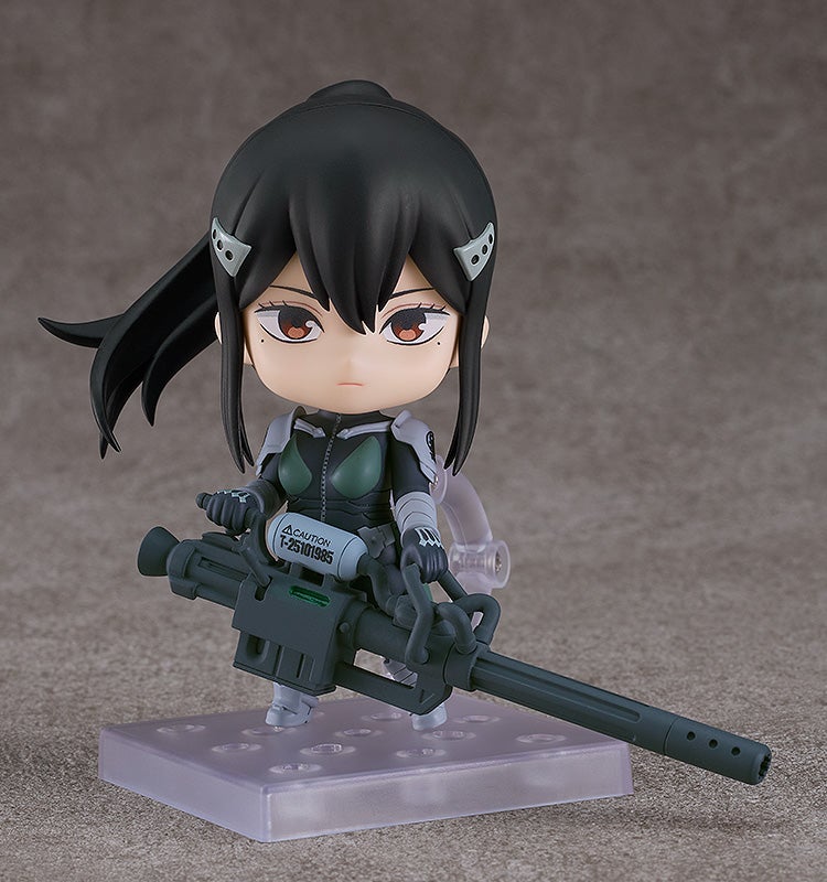 Alternate pose with serious face, holding large pink bazooka diagonally across her body