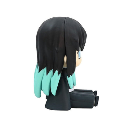 Small seated chibi style anime figurine with black hair and light blue dipped ends