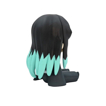 Back view of a black figurine with long teal hair cut in spikes