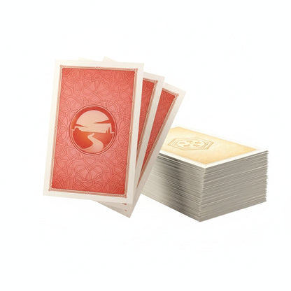 Fanned Gamegenic Catan Art Sleeves show a red back with a sunset and path design, next to a stack of light-colored sleeves with a central symbol