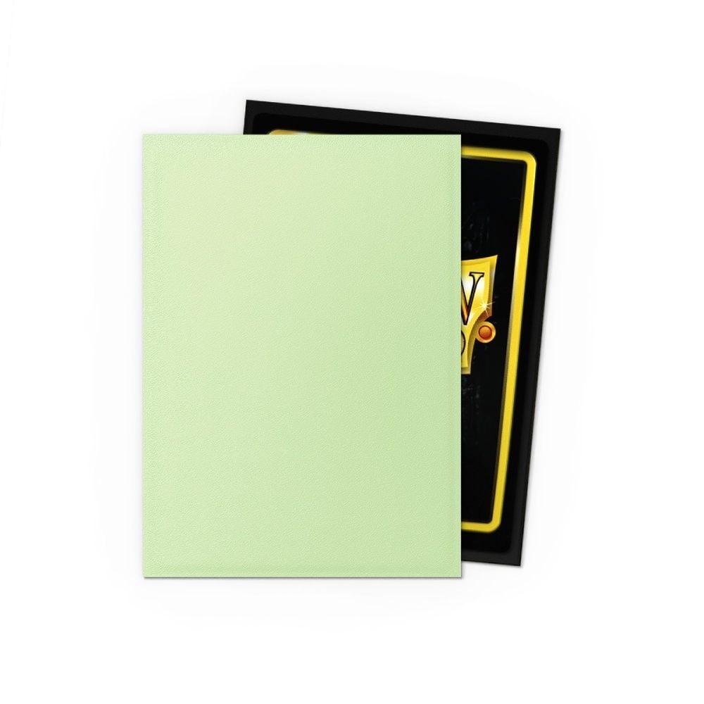 Light green textured card sleeve partially covers a black sleeve with gold border and 'V' design