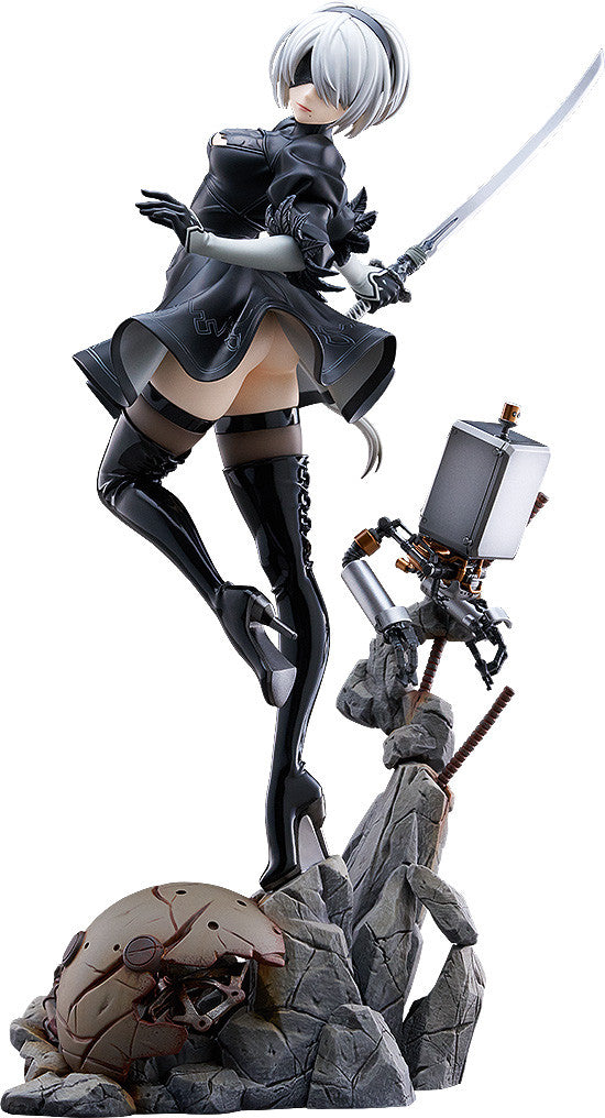 2B figure from Nier Automata in a dynamic pose with a katana, standing on a rocky base with her Pod