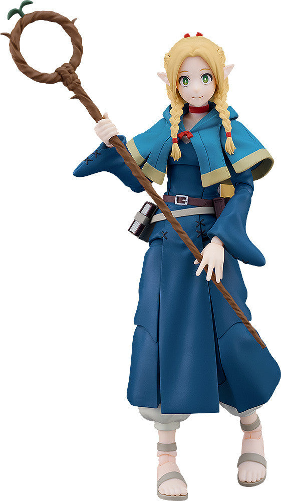Good Smile Company's Figma Marcille figure from Delicious in Dungeon posing with her staff She wears a blue hooded robe a red choker and sandals