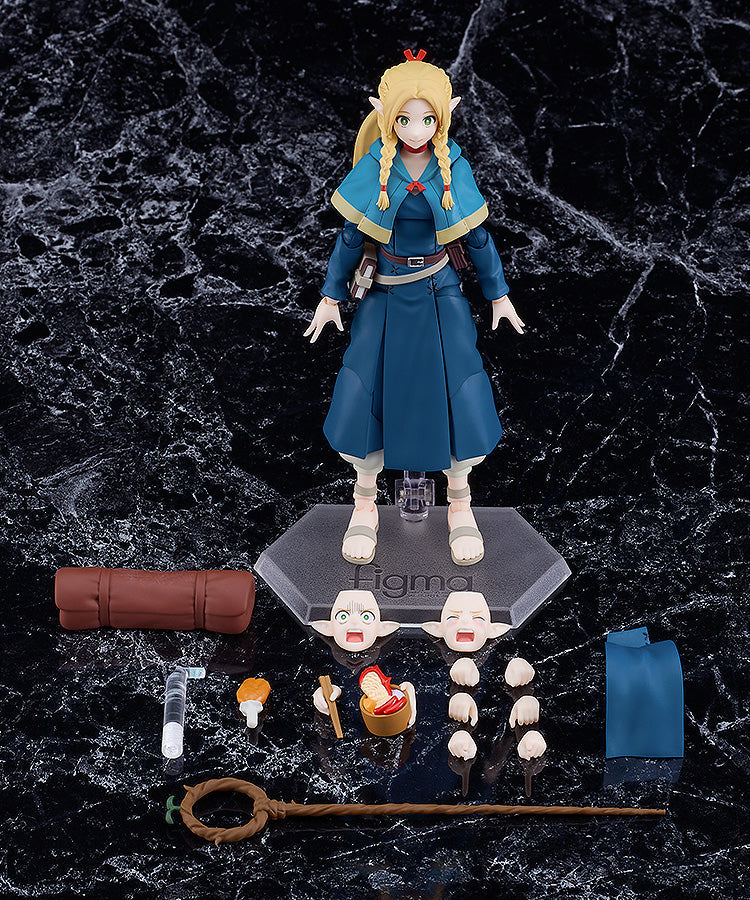 Figma Marcille figure from Delicious in Dungeon with interchangeable faces hands staff spellbook and camping accessories on a black marble background