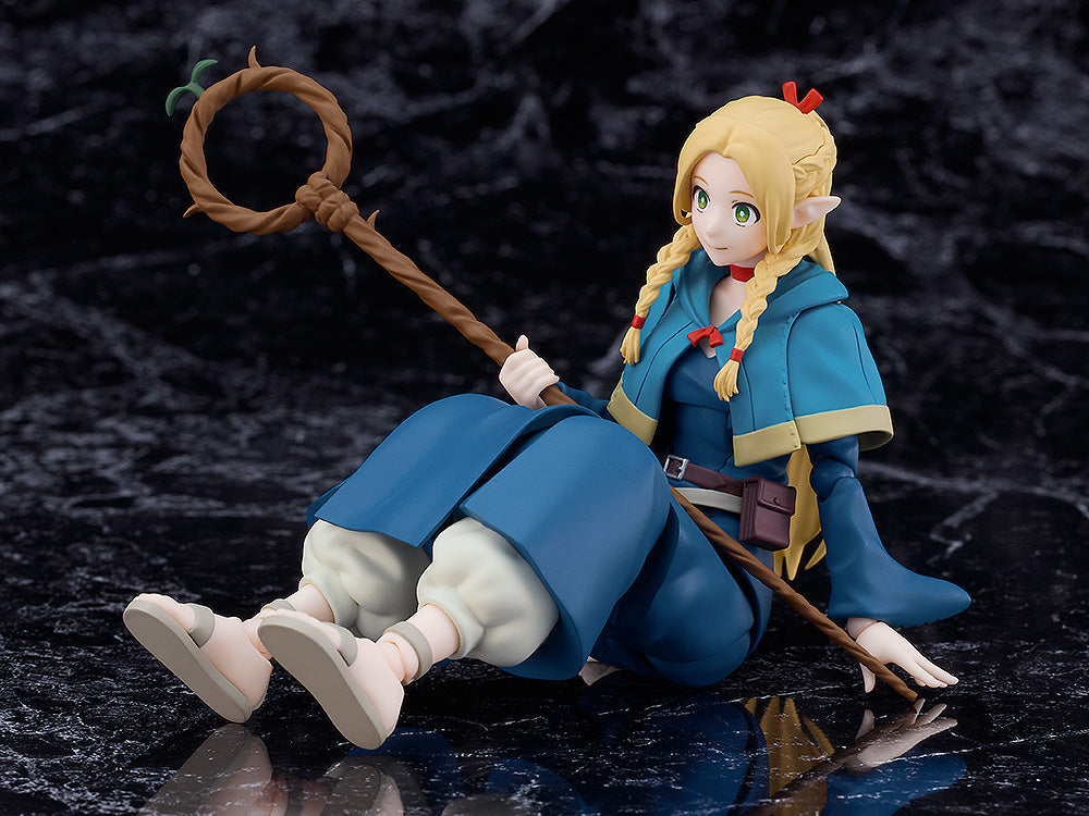 Good Smile Company Delicious in Dungeon figma Marcille figure posed sitting on a dark marbled surface holding a wooden staff with a green leaf accent