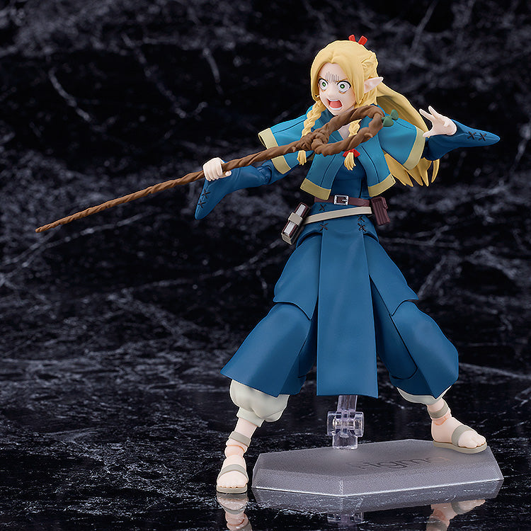 Good Smile Company figma Marcille figure in mid-spell wearing a blue outfit with white undershirt and sandals holding a brown staff posed on a display stand