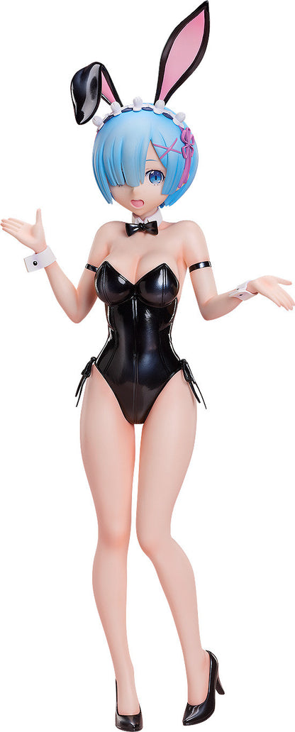 Rem figure in a shiny black bunny suit, blue hair, winking with hands open in a playful pose. She wears pink bunny ears & high heels