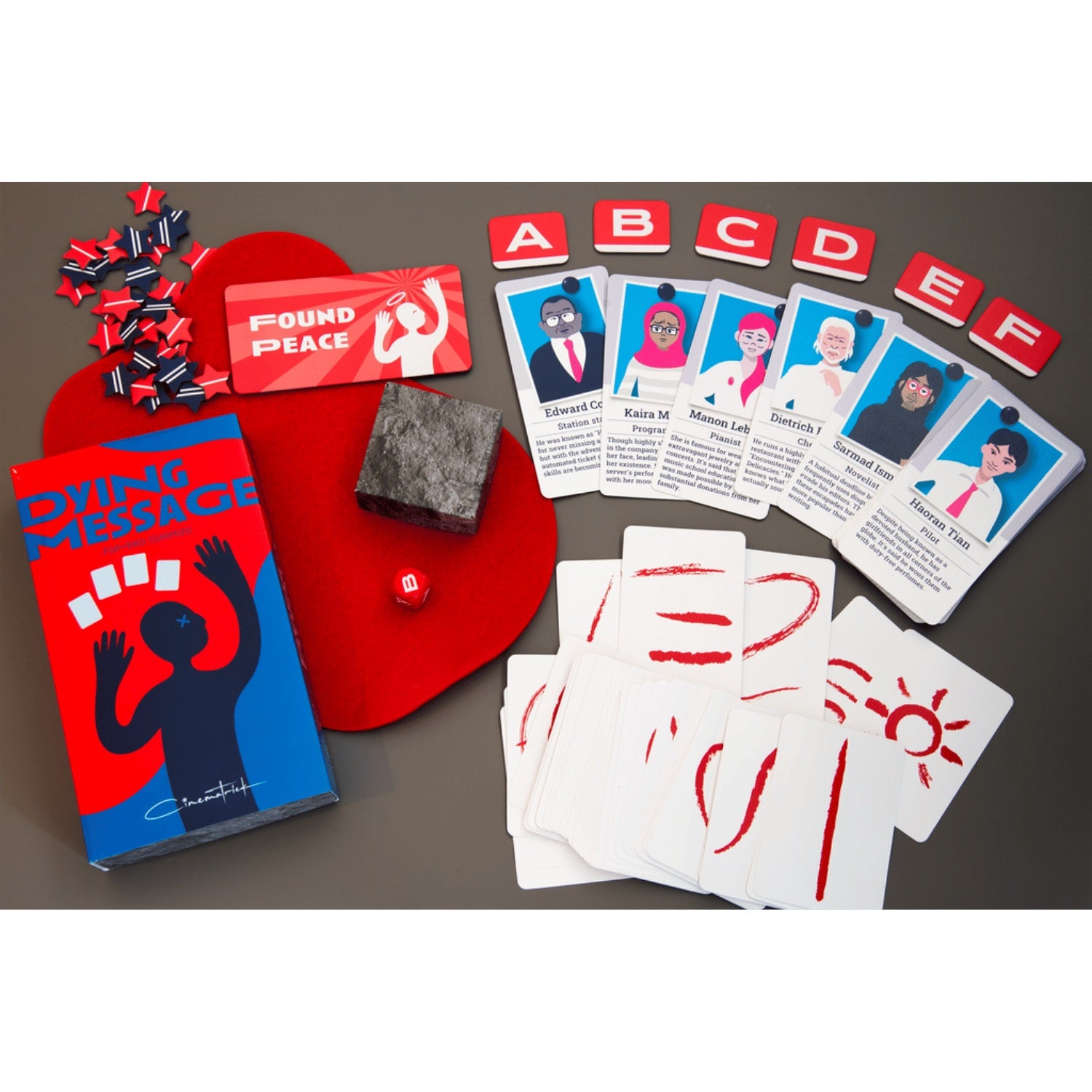 Dying Message board game components including a red box, character cards, white cards with red symbols, star tokens, a red die, and a stone-like block