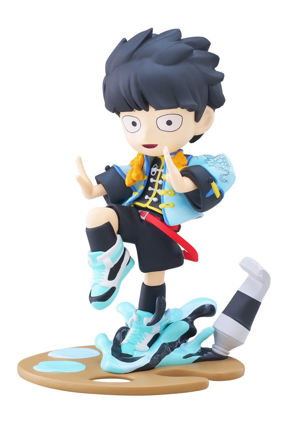 Figure in blue and black outfit with yellow scarf posing on a paint palette base with spilled blue paint and a paint tube on white background