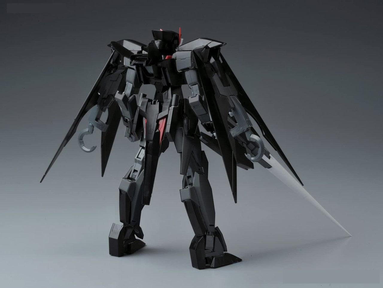 Black mecha model kit, rear view, Large wings feature a long white blade and a silver grapple hook