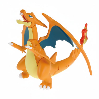 An orange Pokemon Model Kit Mega Charizard Y figure with blue wings, yellow belly, white claws, and a flaming tail stands with its mouth open