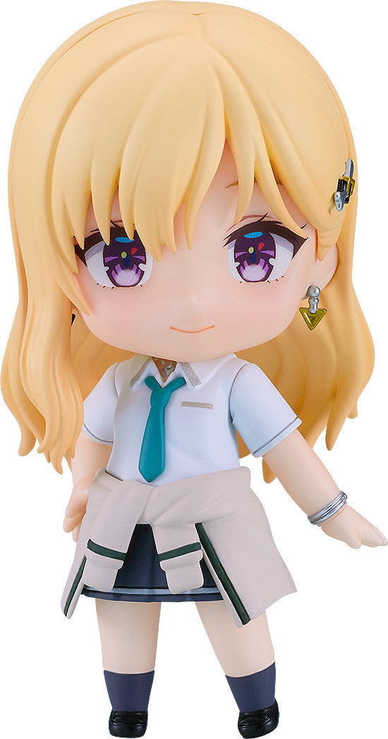 Blonde chibi-style female figure in school uniform with green tie, blue skirt, white jacket at waist, and purple eyes