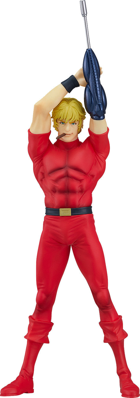 Statue of Cobra the Space Pirate in a red jumpsuit with a black belt and a cigar holding a blue Psychogun above his head