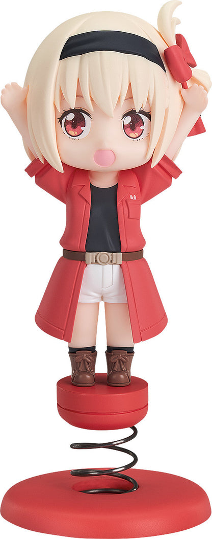 Anime girl figure with blonde hair and red eyes wearing a red coat white shorts and brown boots on a red spring base