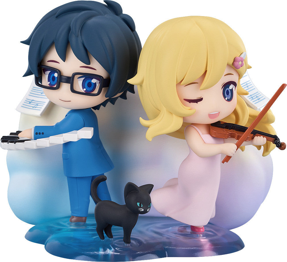 Chibi anime figures: a boy in blue plays piano, a girl in pink winks and plays violin, with a black cat