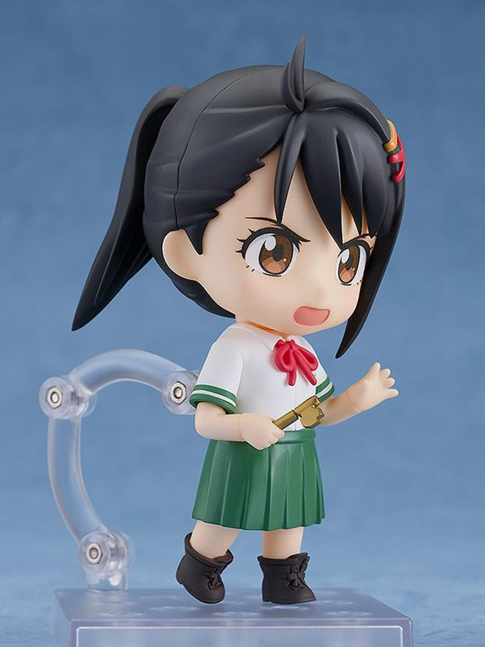 Suzume Iwato Nendoroid figure holding a key and standing on a clear display stand