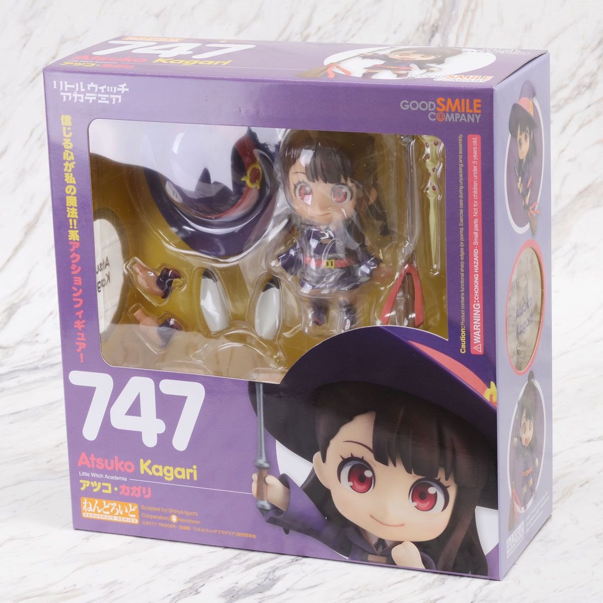 A Nendoroid action figure of Atsuko Kagari from Little Witch Academia in original packaging with visible faceplates and accessories