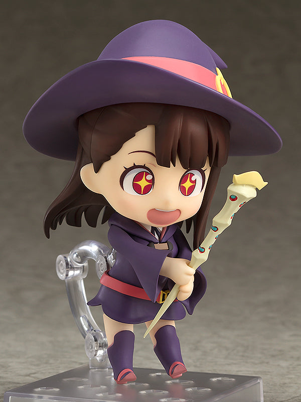 Nendoroid figure of Akko from Little Witch Academia wearing a purple witch hat and robe holding a wand