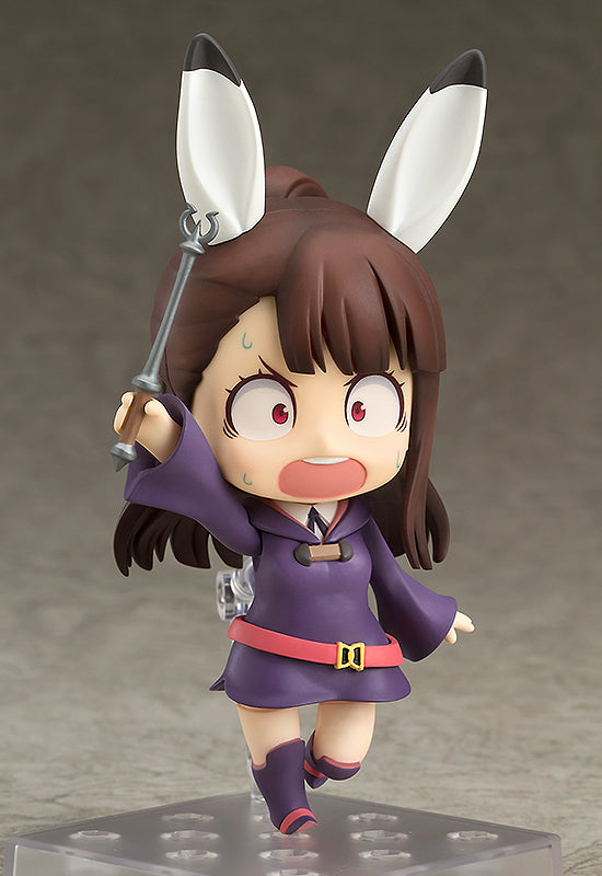 Atsuko Kagari Nendoroid figure in purple robe and pink belt holding a wand and making a scared face