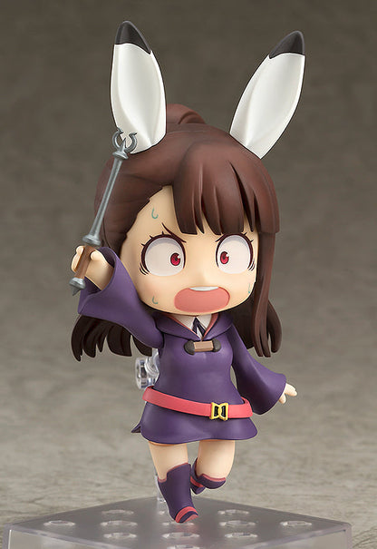 Atsuko Kagari Nendoroid figure in purple robe and pink belt holding a wand and making a scared face